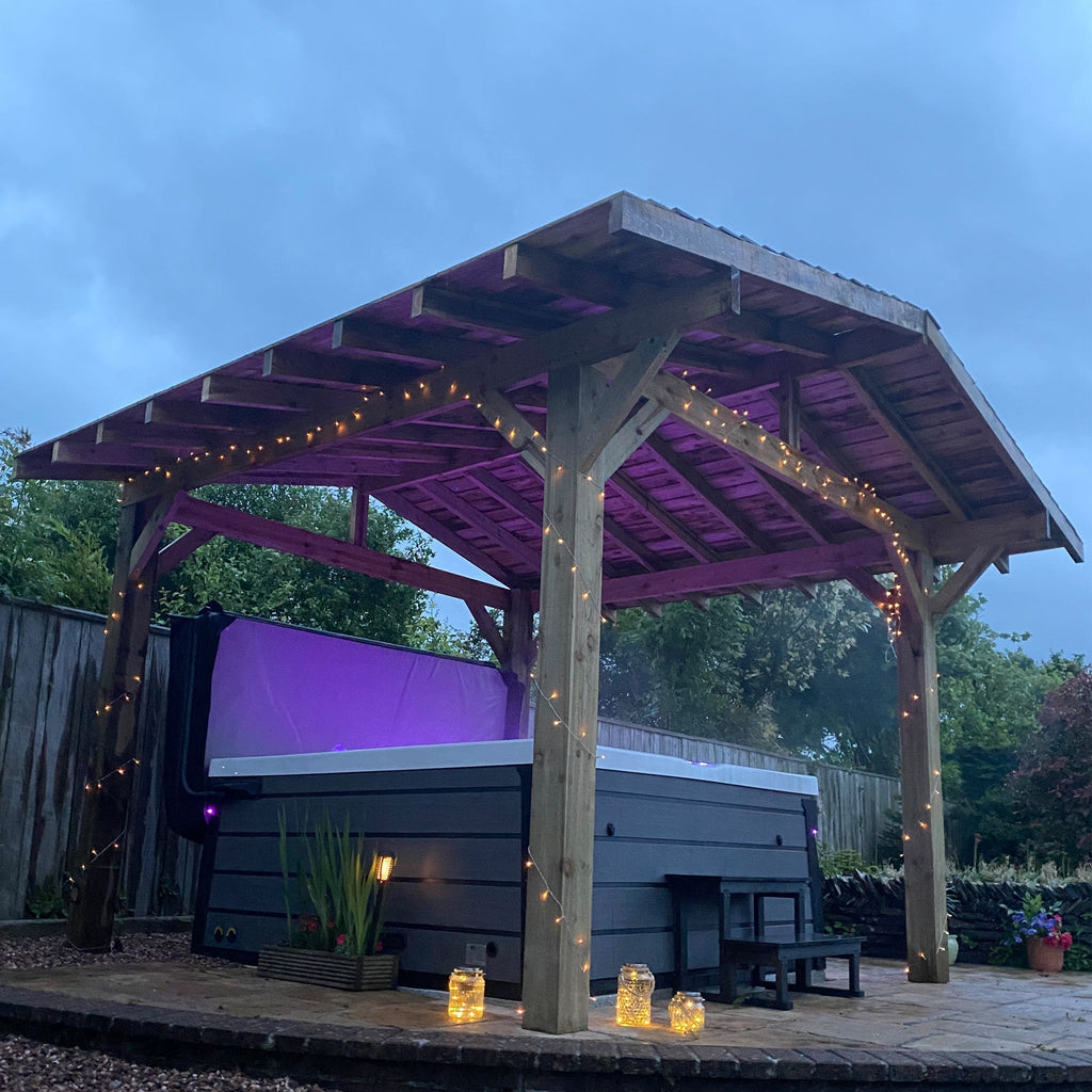 Premium Featheredge Roof Pergola in a wood finish, shown above a hot tub